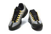 Front view of the Nike Air Max 95 TT sneakers, showing mesh-look panels and yellow lace loops.