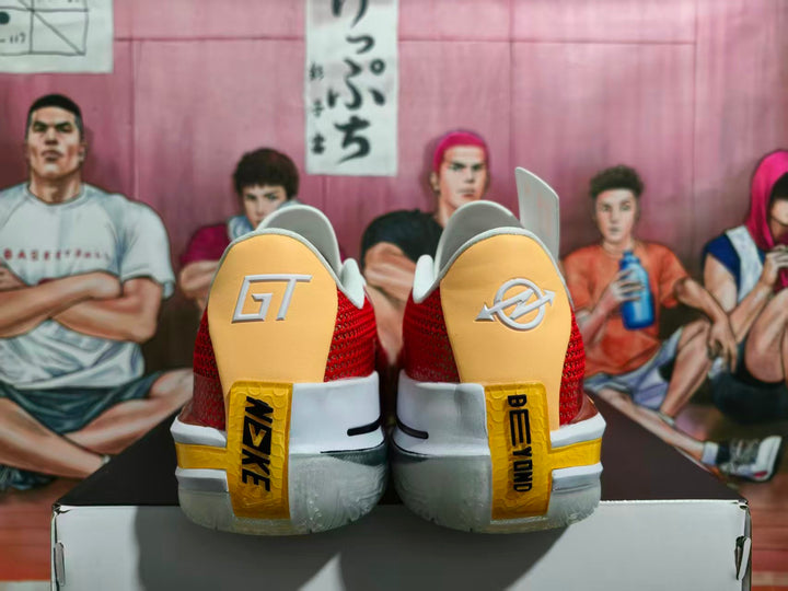 Rear view of red and white Nike basketball sneakers showing gold heel panels, visible branding, and translucent outsoles.
