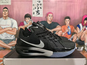 Side view of a black Nike basketball sneaker showing the white Swoosh, gray midsole, blue outsole and ZoomX marking.