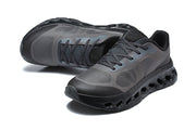 Pair of charcoal On Cloudtilt Remix sneakers viewed from above and the front.