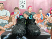 Front view of a pair of black basketball sneakers with blue tongue graphics and textured uppers.