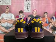 Rear view showing purple and yellow heel panels and dark brown midsoles.