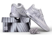 White and silver Nike Sabrina 4 shoes posed above a shoe box