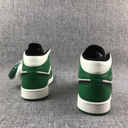 Rear view of both sneakers showing the green heel panels and white collars.
