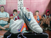 Angled view of the pair showing the textured uppers, blue and orange side accents, and patterned outsoles.