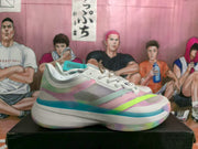 Side view showing the mesh-look upper, pastel panels, lime accent, and blue trim above the sole