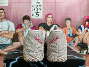 Rear view of light pink basketball shoes with “TWELVE” lettering on the heels.