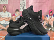 Black running shoes shown at an angle, highlighting the side panels and sculpted soles.