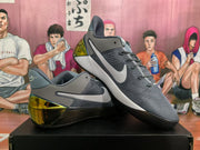 Angled view of wolf gray Nike basketball sneakers highlighting the textured upper, side Swoosh, and heel detail.
