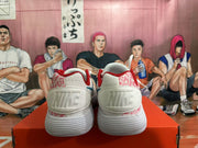 Rear view of white Nike shoes with pink patterned heel panels and red collar lining.