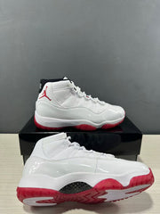 White and red Jordan Air Jordan 11 Retro Low sneakers shown from the side and outsole angles.