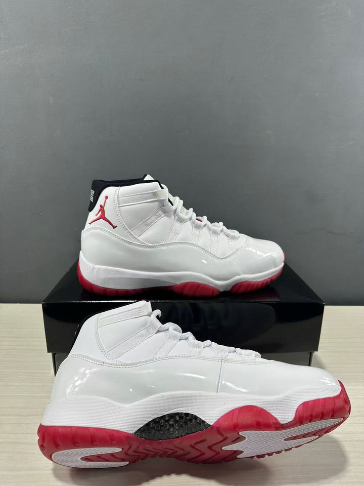 White and red Jordan Air Jordan 11 Retro Low sneakers shown from the side and outsole angles.
