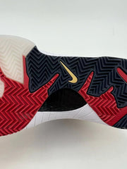 Close-up of the shoe outsole showing black, red, and translucent sections with patterned tread.