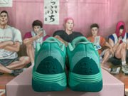 Rear view showing textured heel panels and darker green heel details.