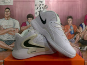 Angled view of the paired white Nike Zoom basketball sneakers with black branding and textured soles.