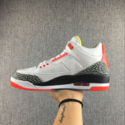 Opposite side view showing the white upper, elephant-print overlays, and red outsole.