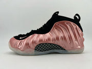 Black high-top sneaker with a metallic rose-pink side panel.