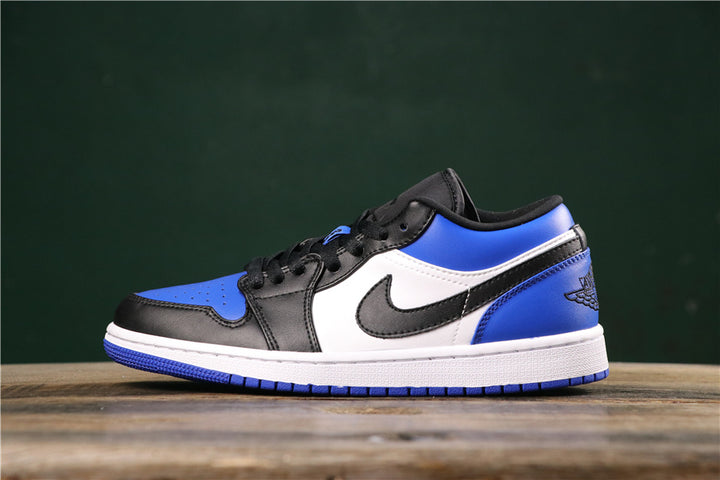 Side view of a royal blue, black and white low-top Jordan sneaker with contrasting panels and a heel Wings-style mark.