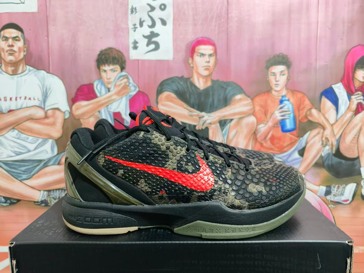 Side view of black, olive, and red camouflage Nike basketball sneakers displayed on a black shoebox.