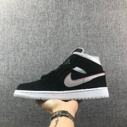 Side profile showing the black upper, silver side panel, red edging and white midsole.