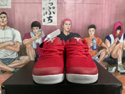 Front view of red Nike basketball sneakers with white textured outsoles and red laces.