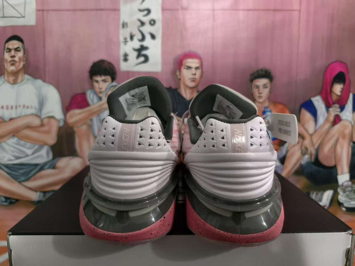 Rear view of pink and light-colored Nike basketball sneakers on a box, showing layered heel detailing and dark collar padding.