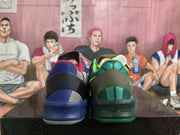 Rear view of the mismatched sneakers showing contrasting blue and green heel sections with textured outsoles.