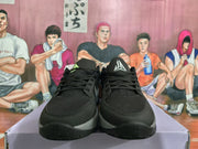 Front view of black and grey Nike sneakers with black mesh uppers, black laces, and contrasting midsoles.