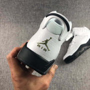 Close-up of the heel showing the textured white upper, heel branding, and black outsole.