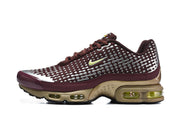 Side profile of a burgundy and silver Nike Air Max Plus VII sneaker with gold-toned sole details.