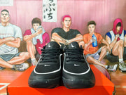 Front view of black Nike basketball sneakers with lace-up closures and white accents