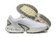 White and grey Nike Air Max DN sneakers with outsole tread visible.