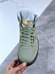 Front view showing the green toe box, lacing system, padded tongue, and Jordan logo.