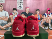 Rear view of red low-top sneakers with matching heel panels, Jumpman emblems, and cream-colored outsole sections.