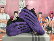 Angled view of the pair highlighting the purple side panels, black accents, and outsole structure.