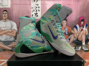 Angled view of the matching pair showing patterned green side panels, dark blue swooshes, teal laces, and high-top collars.