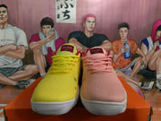 Front view showing the yellow and pink uppers, matching laces, spot details, and white toe soles.