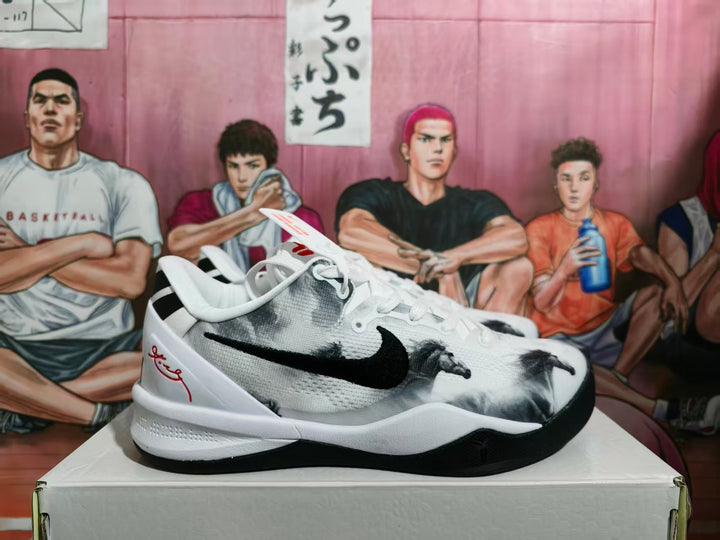 Side view of white and black Nike basketball sneakers displayed on a shoebox.