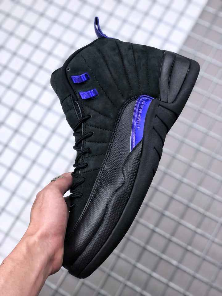 Side view of a black Air Jordan 12-style high-top sneaker with dark purple eyelets and side detailing.