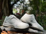 Pair of white Kobe 4 shoes displayed at an angle