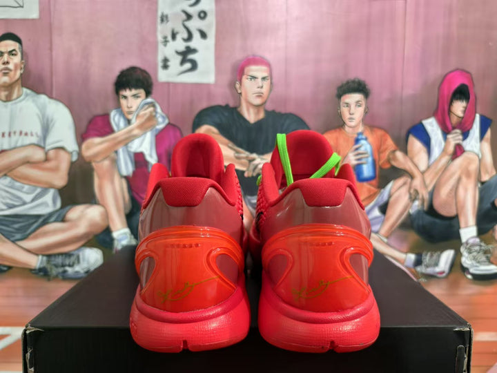 Rear view of red Nike basketball sneakers showing the padded collars, translucent-looking heel sections, and dark red detailing.