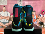 Rear view showing black heel panels and patterned blue side panels on the high-top shoes.