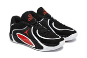 Three-quarter view of the black, white, and red lace-up basketball sneakers with visible Jordan side branding.