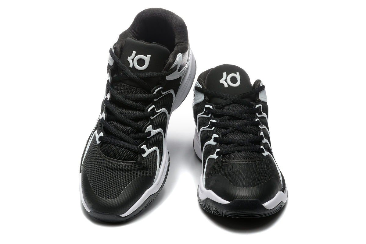 Front view of black and white Nike basketball-style sneakers with lace-up fronts and contrasting side details.