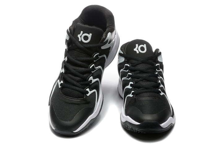 Front view of black and white Nike basketball-style sneakers with lace-up fronts and contrasting side details.