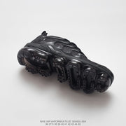 Outsole view of a black Nike Air VaporMax Plus sneaker with model, style code, and size text.