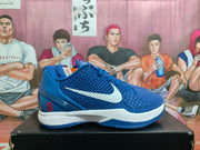 Side profile of a blue Nike Kobe basketball shoe with a white Swoosh, textured upper, and red number 8 heel detail.