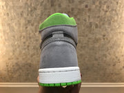Rear view showing the grey heel, green collar and white midsole above the green outsole.