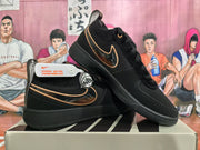 Pair of black Nike Sabrina basketball shoes with gold accents, shown at an angle.