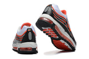 Rear and outsole views of Nike sneakers with black, white, and orange details.